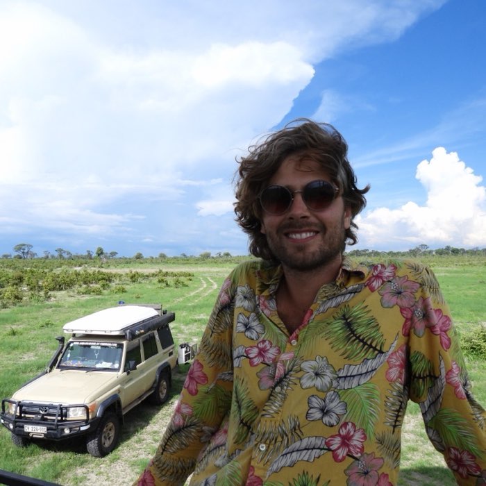 Mitchel Wubben in front of his Land Cruiser on the plains