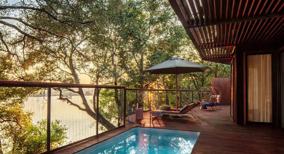 A plunge pool overlooks the river from a shaded deck at Anantara Tented Camp Kafue River.