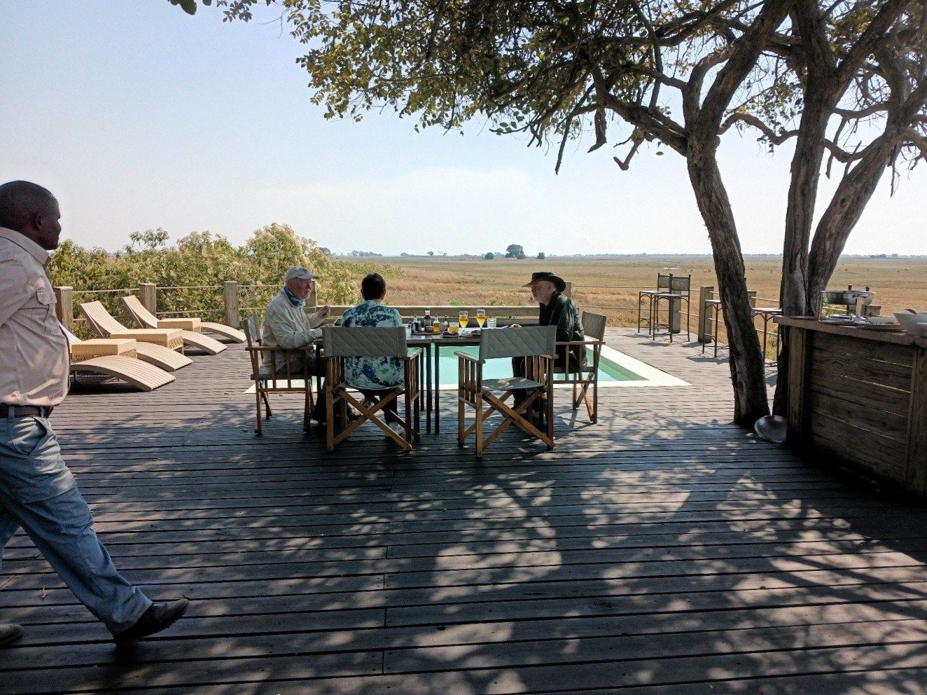 Guests share brunch beside the pool deck at Busanga Bush Camp.