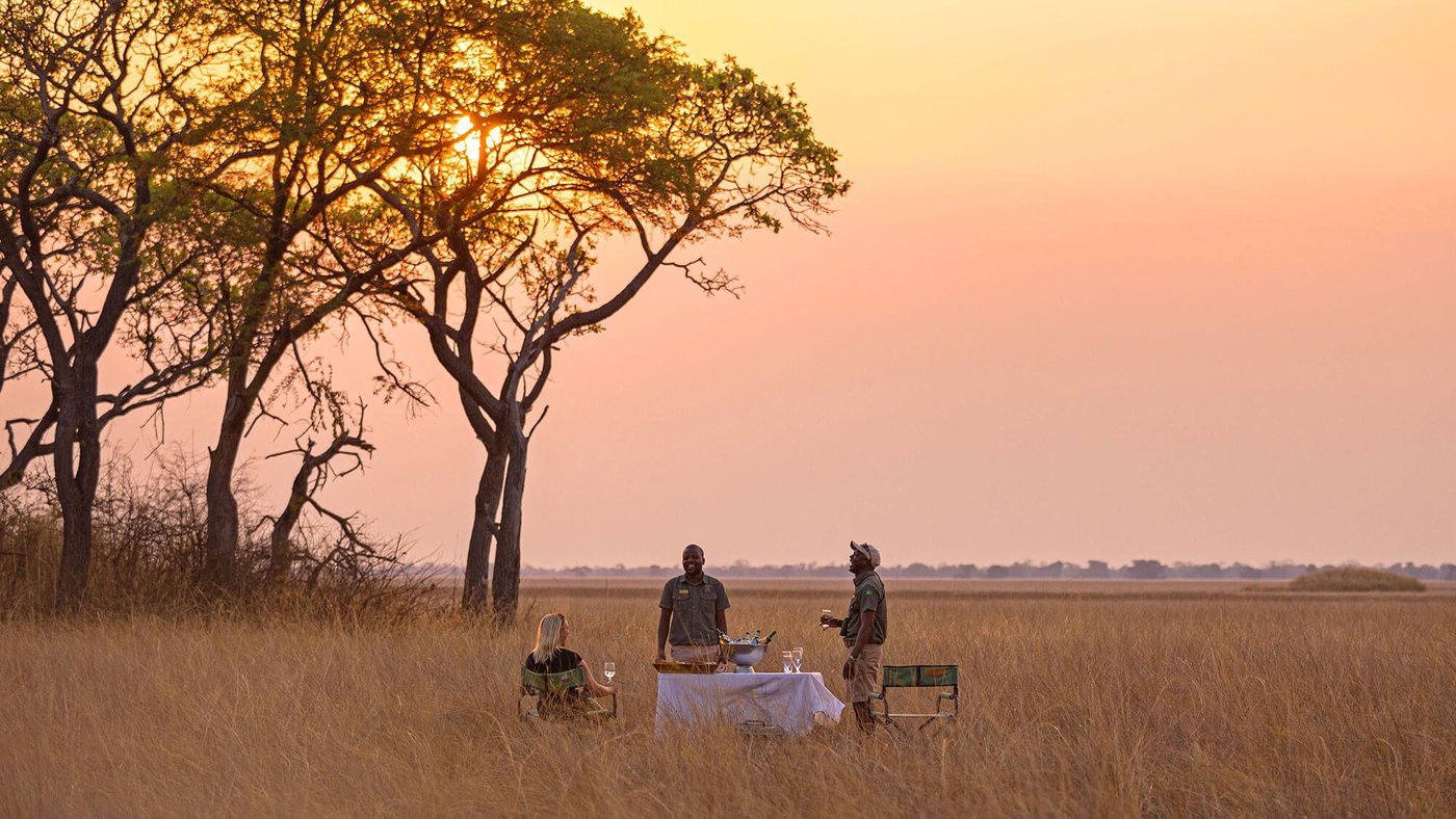 A guide serves a private breakfast on the plains near Chisa Busanga Camp.