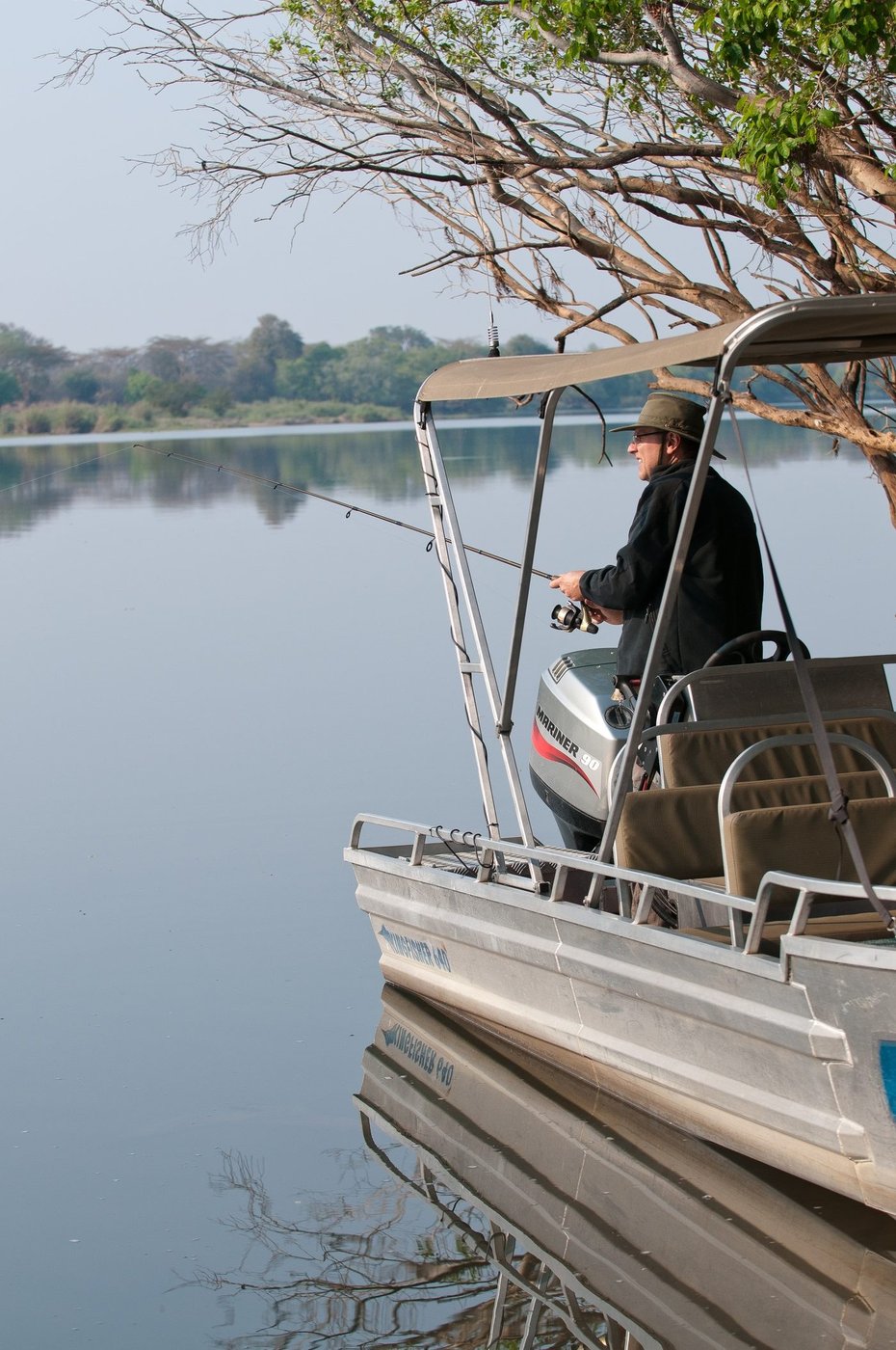 A guide steers a boat for catch-and-release fishing near Hippo Lodge.