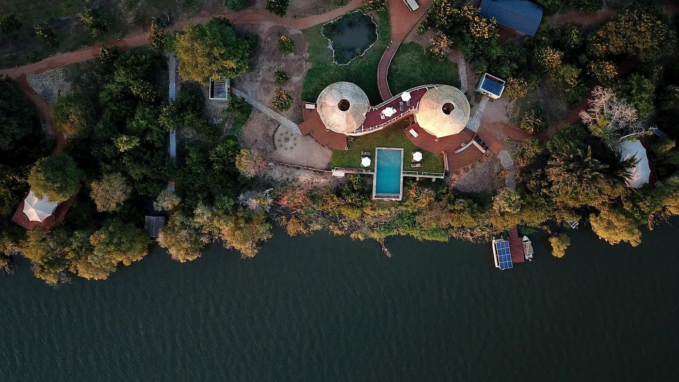 An aerial view shows the round pod buildings and pool at Ila Safari Lodge in Kafue.