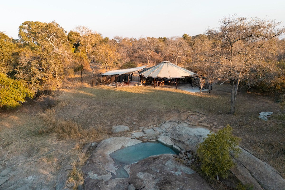 An aerial view shows the thatched chalets and pool at Kasabushi Camp in Kafue.