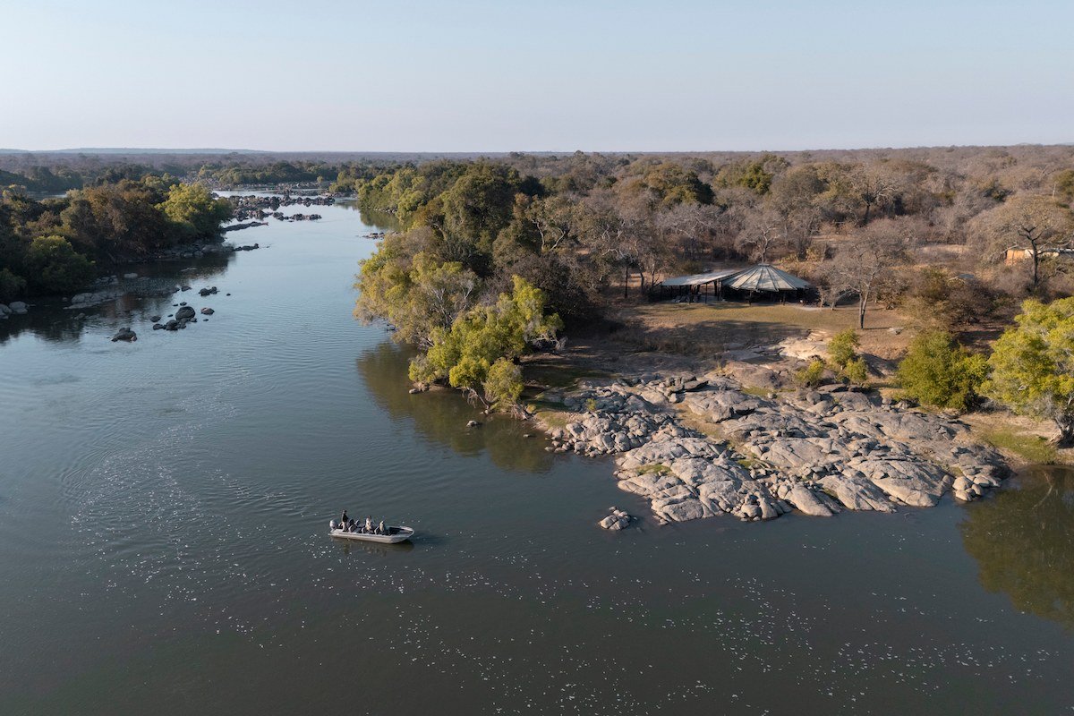 An aerial view traces rapids and islands on the river at Kasabushi Camp.