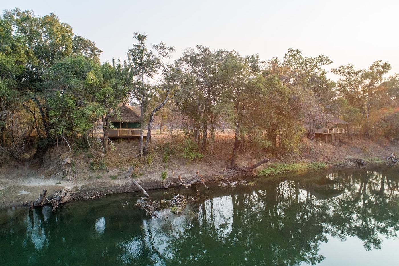 Morning mist rises over the riverbank camp at Lunga Kikuji Camp.