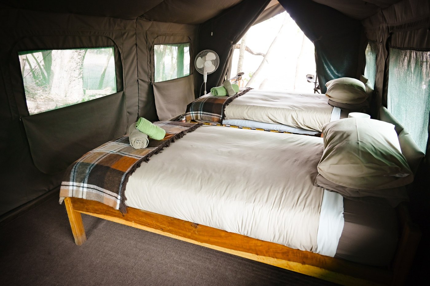 A four-poster bed sits inside a safari tent at Mapunga Bush Camp.
