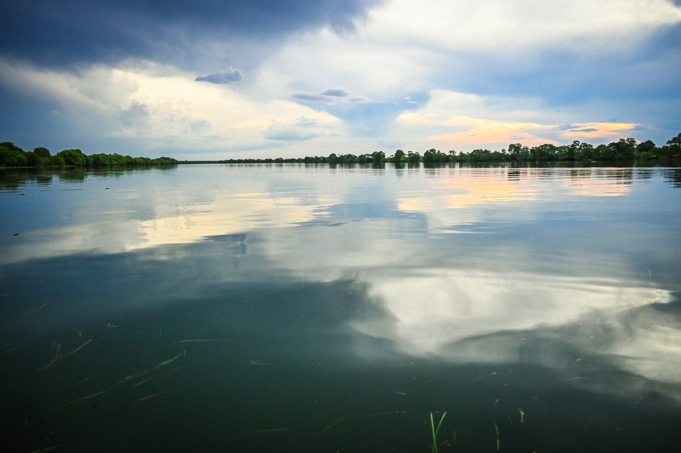 Still water mirrors the sky at dusk near Mapunga Bush Camp.