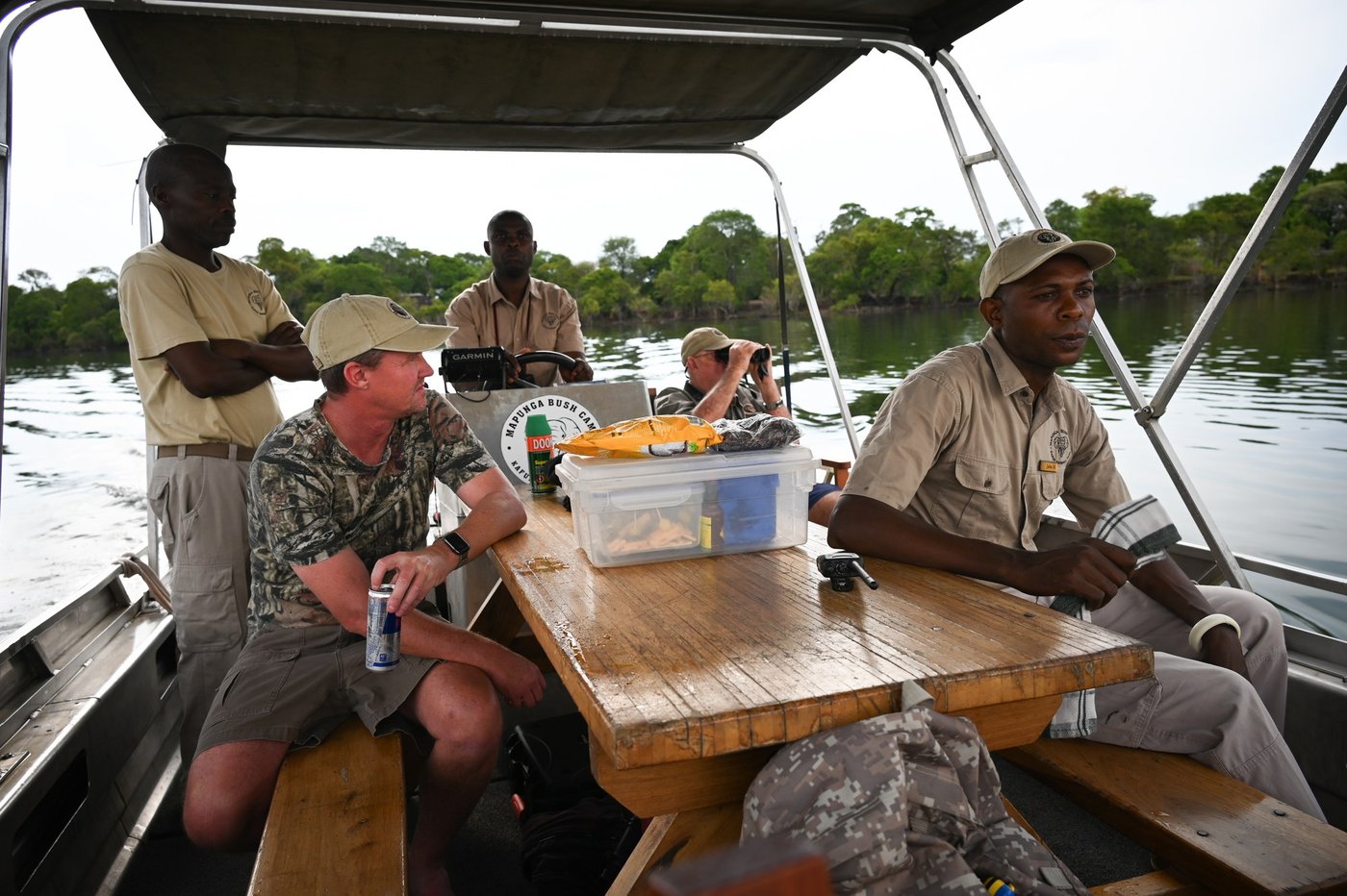 Guides share a boat ride on the river near Mapunga Bush Camp.