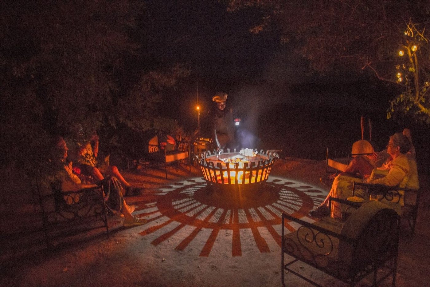 Guests gather around a fire pit for dinner at McBrides' Camp.