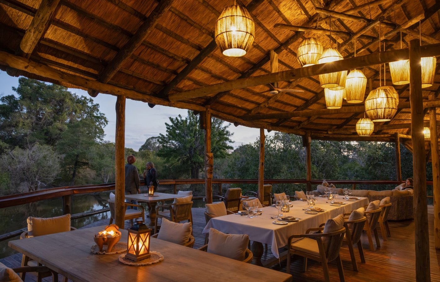 Lanterns light the open-sided dining hall at Mozhi Bush Camp.