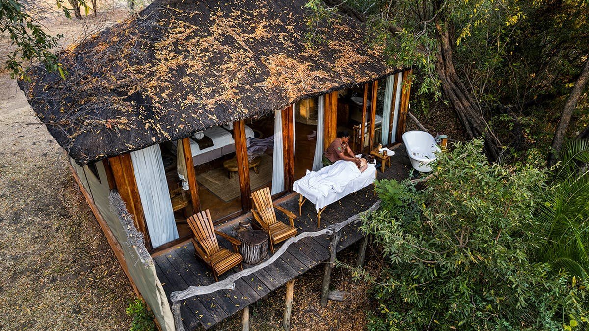 This treetop chalet at Mukambi Safari Lodge includes a private deck and freestanding tub.