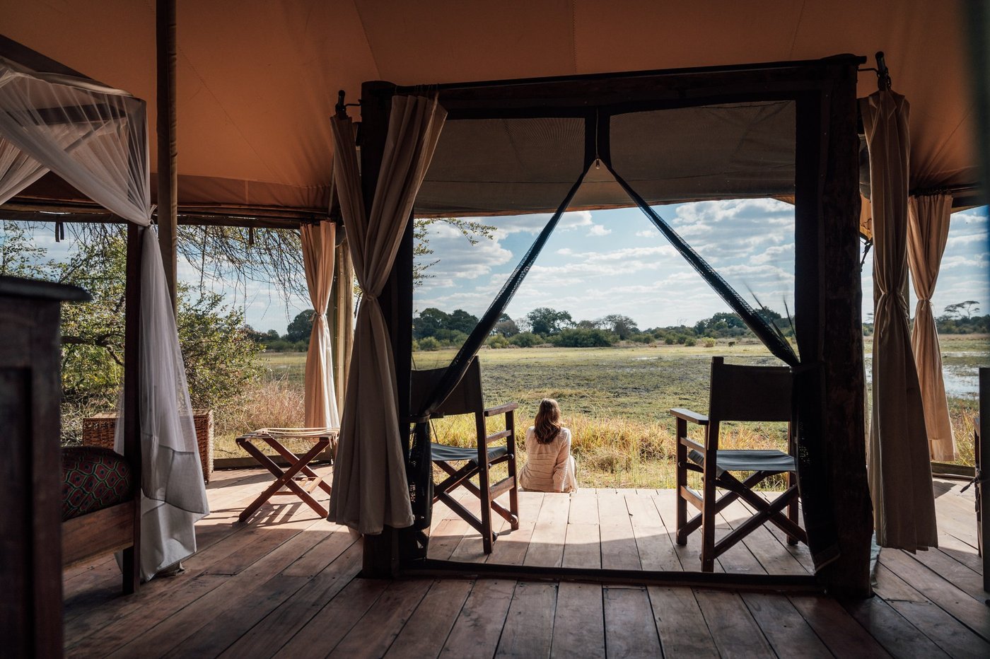 A tented suite bed sits beneath a canvas canopy at Musekese Camp.