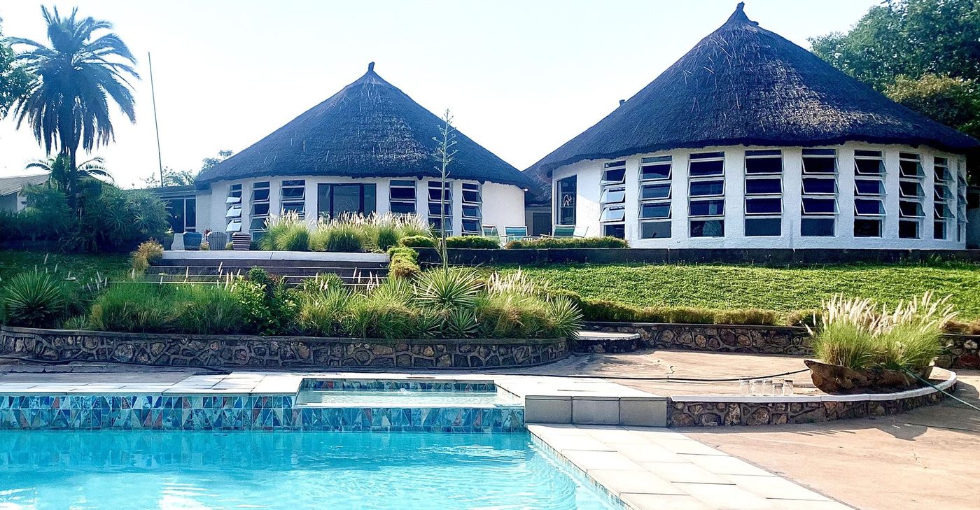 Twin thatched rondavels overlook the pool at Musungwa Safari Lodge in Kafue.