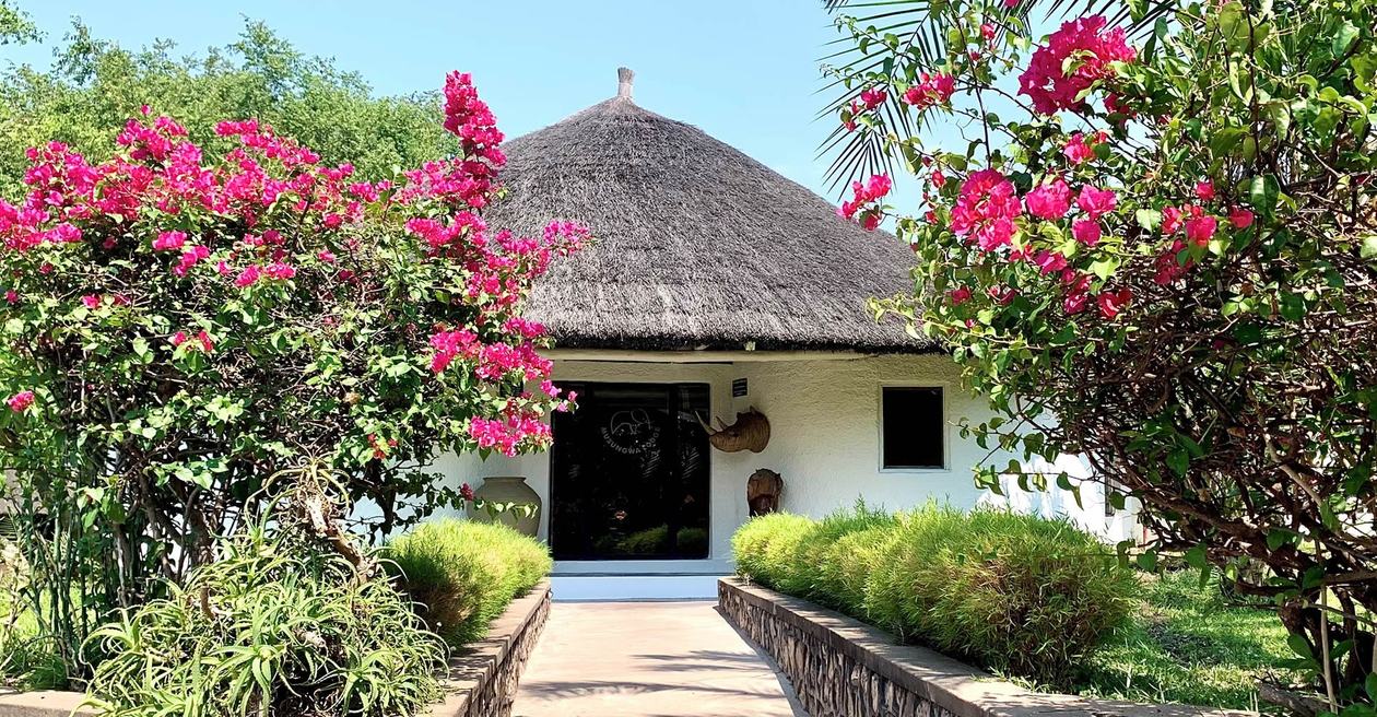 A garden path lined with bougainvillea leads to Musungwa Safari Lodge.