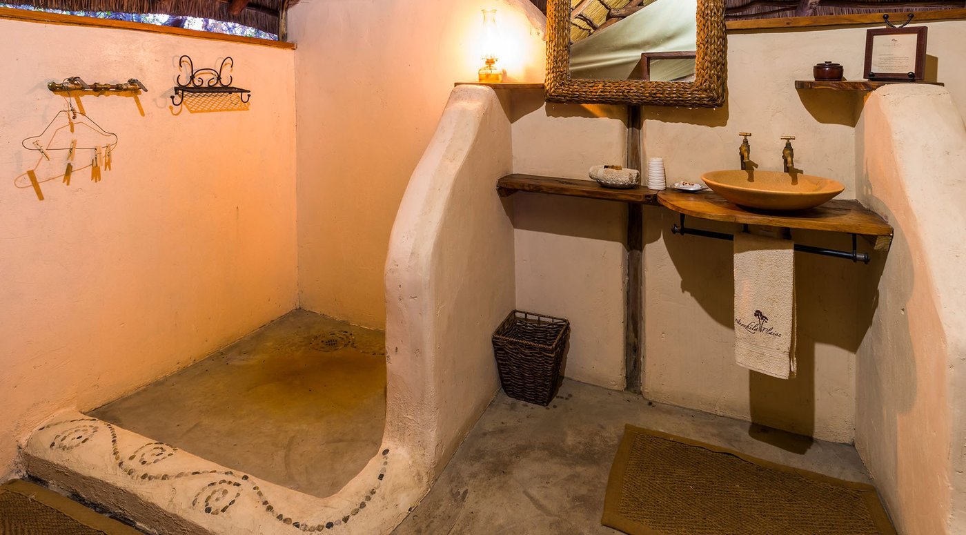 A stone washbasin stands in the en-suite bathroom at Nanzhila Plains Camp.