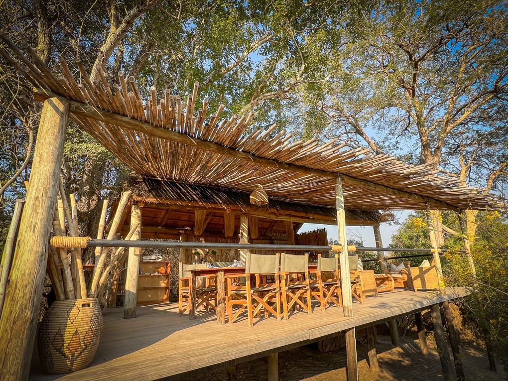An open-sided thatched deck serves as the dining area at Ntemwa-Busanga Camp.